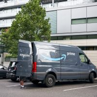 Portland, Oregon, USA - Sep 13, 2019: An Amazon worker is seen unloading an Amazon Prime branded van on the roadside in downtown Portland.